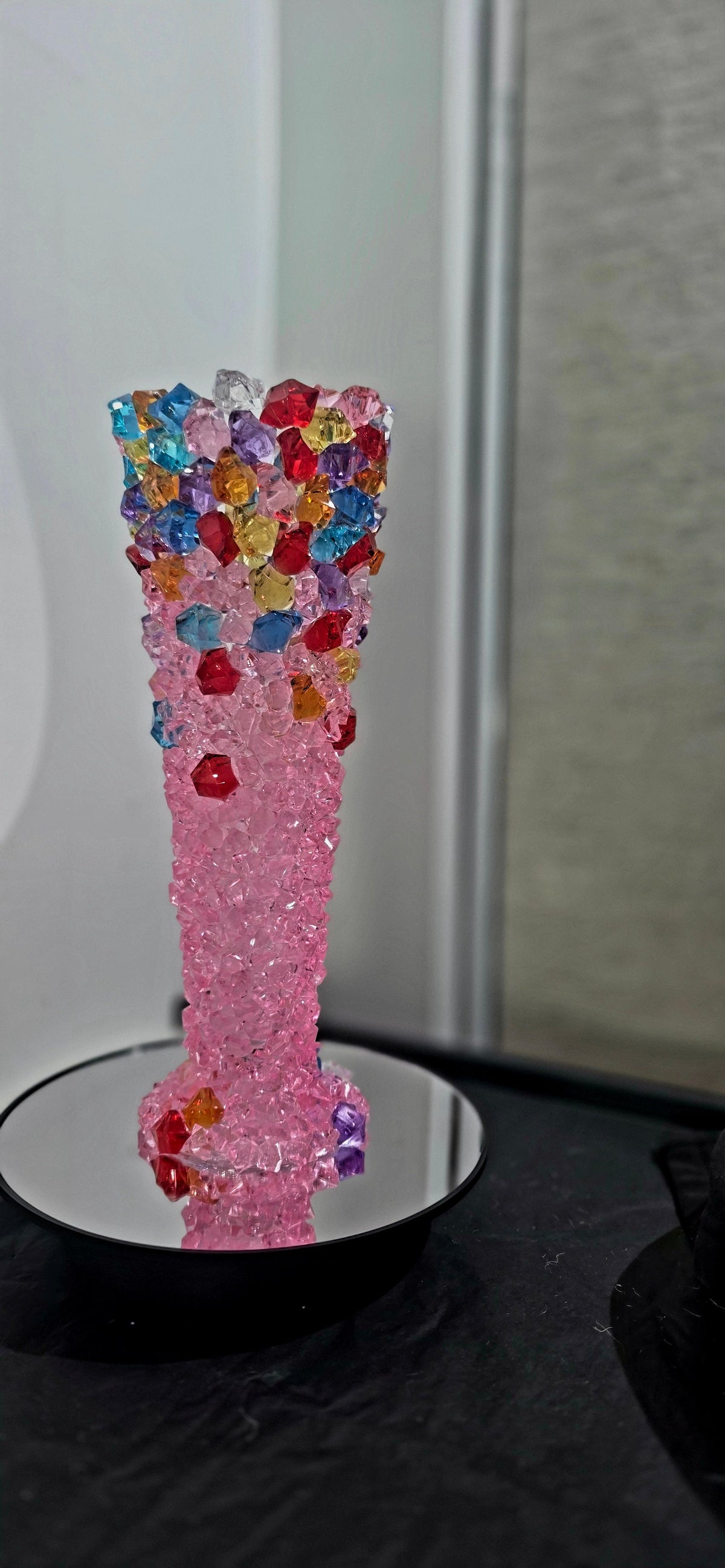 Pink crystal gem embellished vase with multicoloured gems on a mirror base
